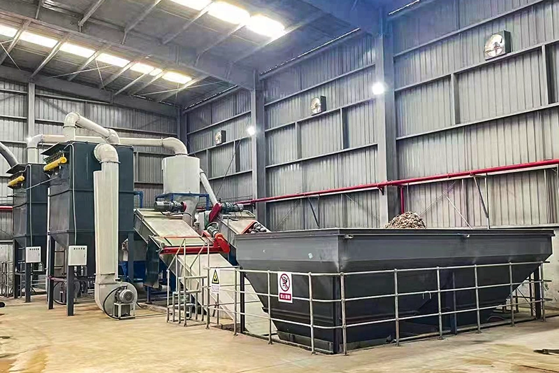 Wood chip crusher integrated at the source with sawdust hopper and dust collection for on-site wood waste volume reduction