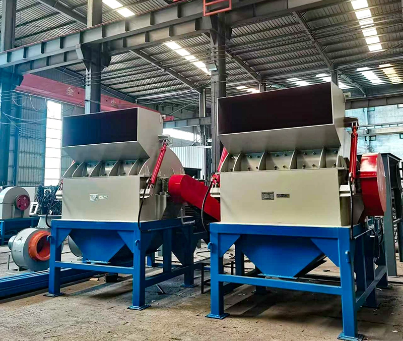 Close-up of red rotor and manganese steel hammers on a wood pallet crusher for recycled pallet feedstock.