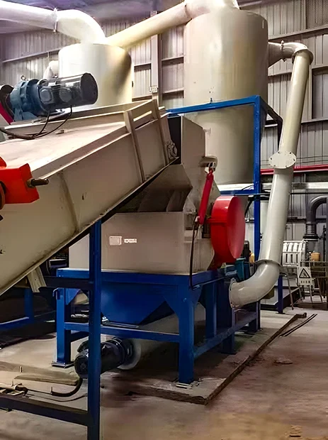 Industrial wood waste powder handling system with hopper, enclosed conveyor, rotary valve assembly and dust collection ducting feeding a wood pulverizer front end