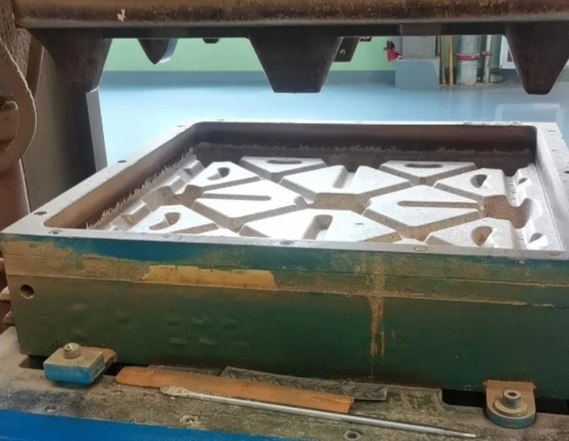 Closeup of an open steel mold cavity with structural ribs, showing AutoML presswood pallet machine tooling for a smooth nail-free wooden pallet process in warehouse Zero Harm handling.