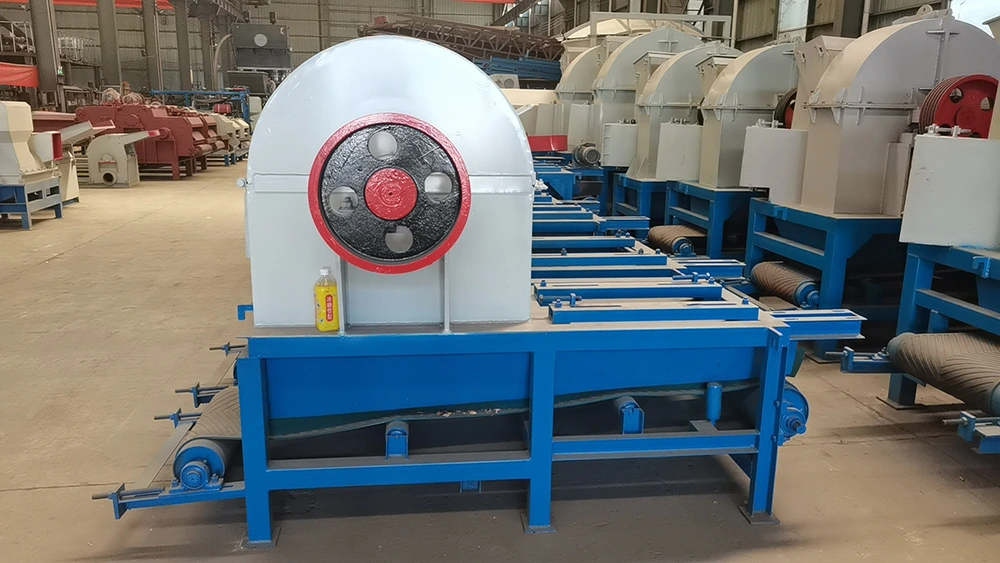 commercial wood chipper discharge of uniform 30 to 35 mm wood chips downstream of a hammer mill