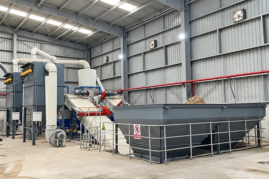 Industrial waste processing line with heavy-duty steel feed hopper, inclined conveyors, and dust extraction ducts