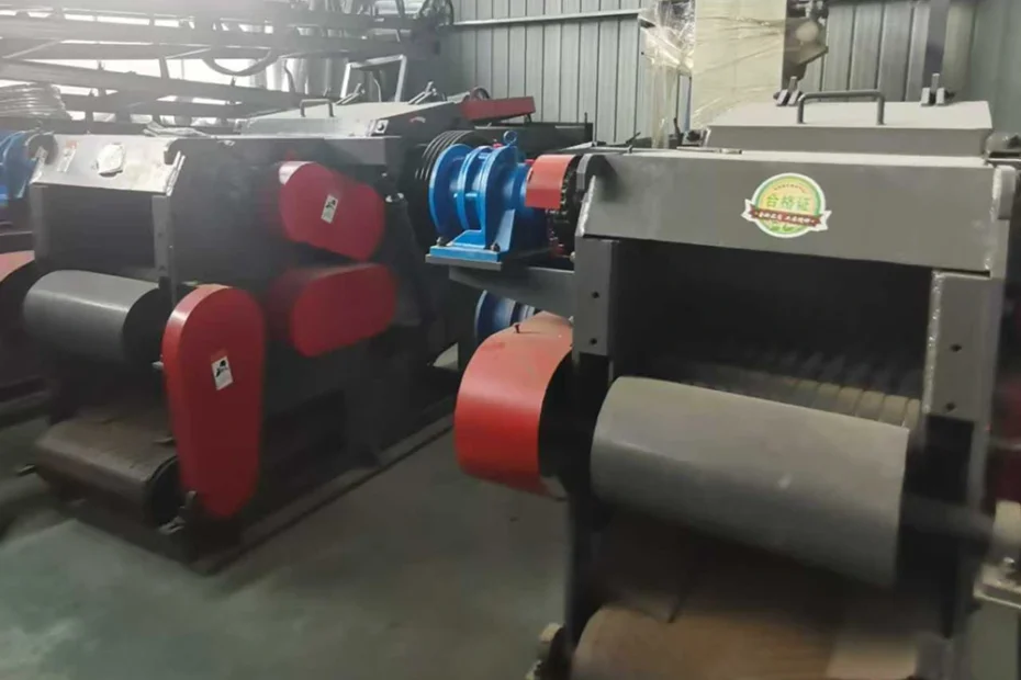 Emp-Shred industrial roller shredder with twin horizontal rollers, red belt guards, blue drive pulley, and steel housing