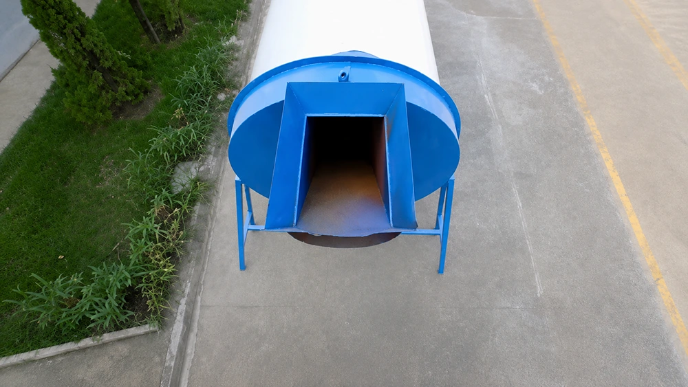 Blue cylindrical drying unit with rectangular front chute, curved guard panels, and steel support legs