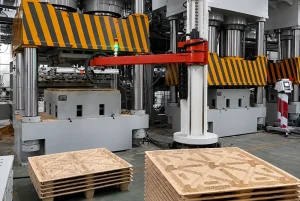 Heavy-duty multi-column hydraulic press with striped safety covers and automated handling arm.